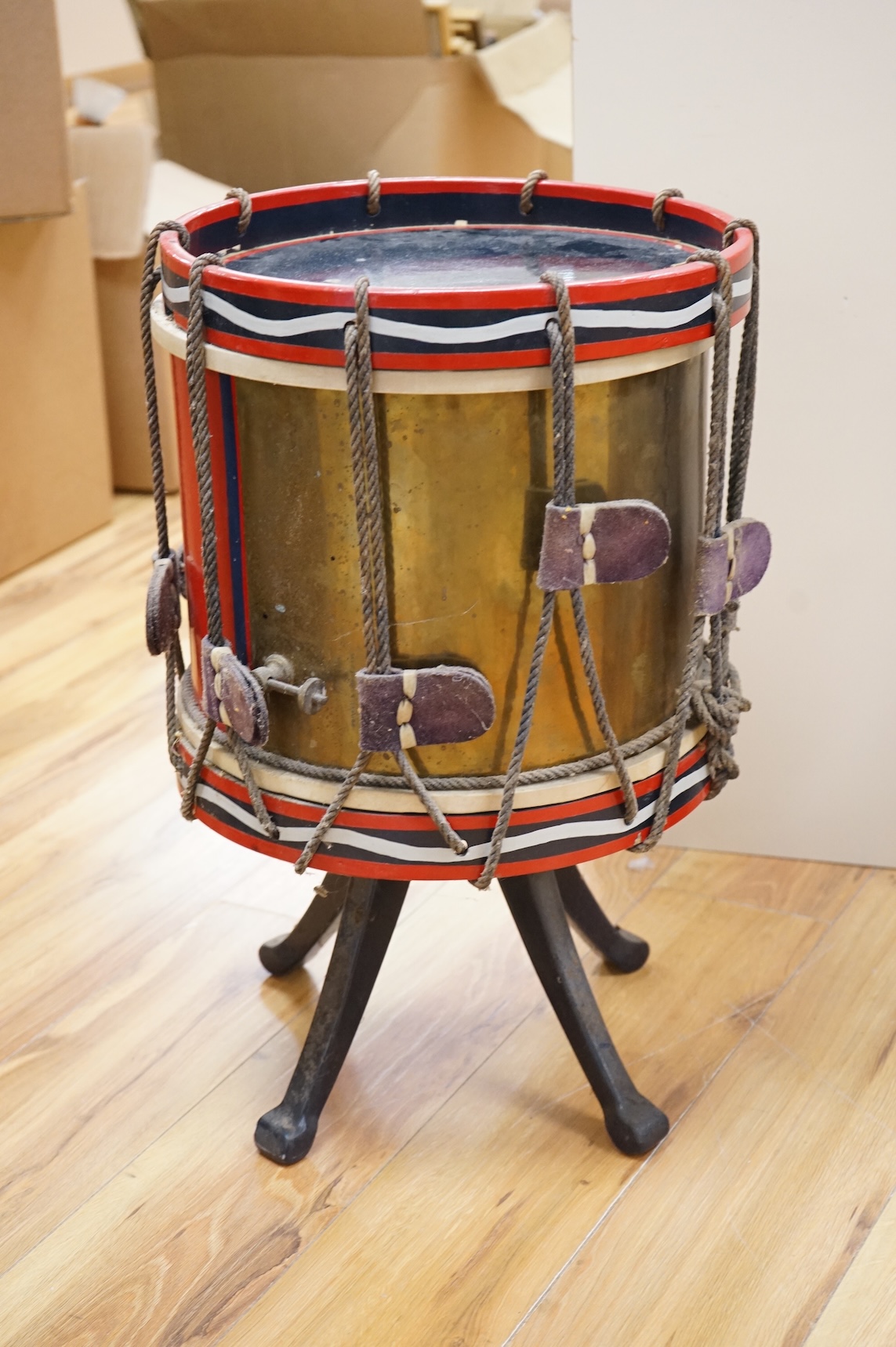 A red painted Regimental drum shaped table, 62cm high